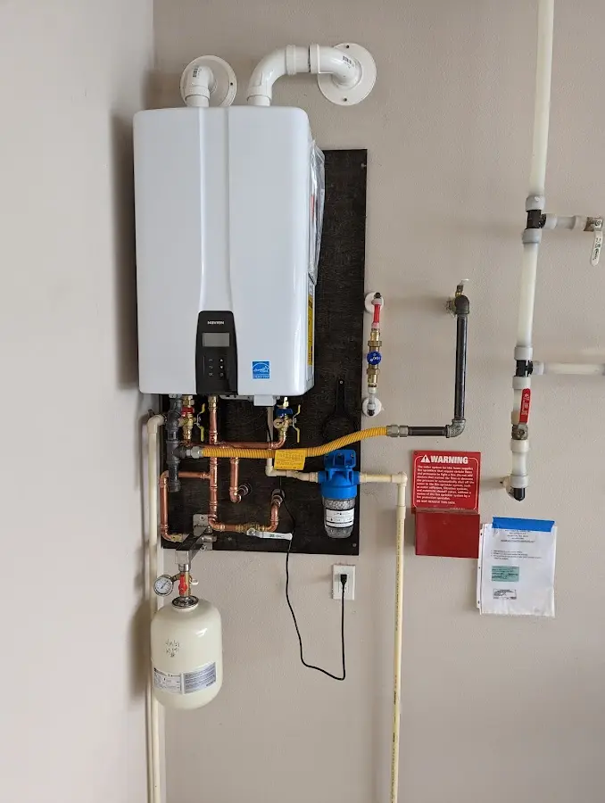 Professional plumber installing copper piping in a Salinas home